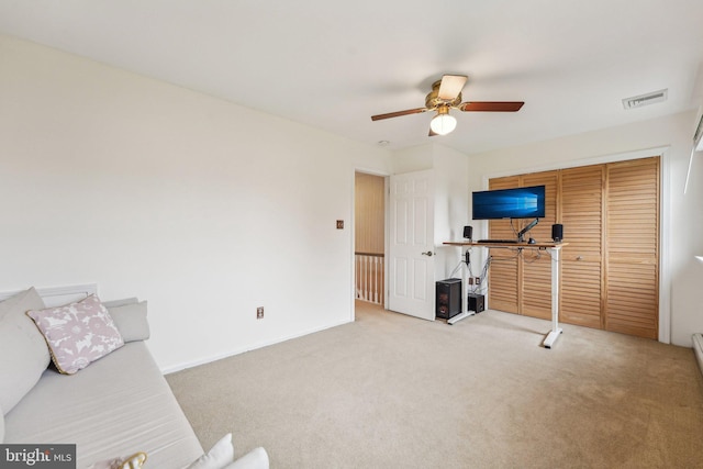 unfurnished living room with ceiling fan and carpet flooring