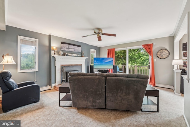 living room with carpet, a ceiling fan, a fireplace with raised hearth, crown molding, and a baseboard radiator