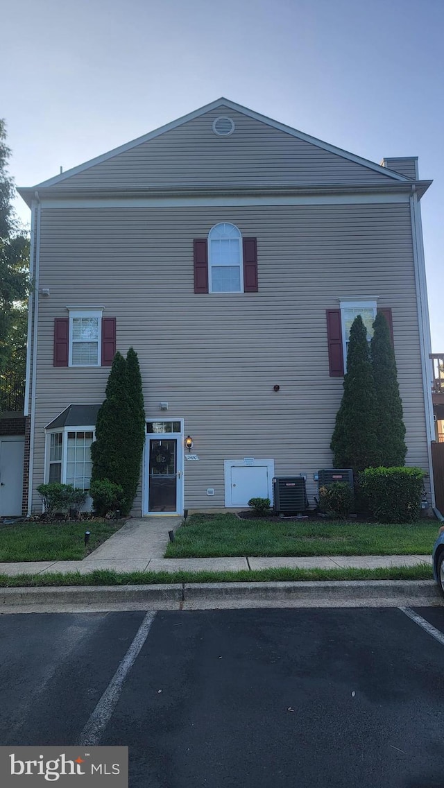 view of side of home featuring uncovered parking and central air condition unit