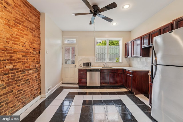 109 N Collington Ave, Baltimore, MD 21231 - kitchen with appliances with stainless steel finishes, light countertops, a ceiling fan, brick wall, and recessed lighting