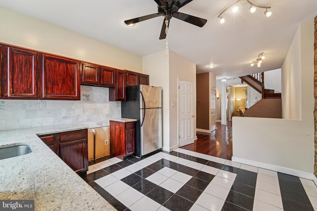109 N Collington Ave, Baltimore, MD 21231 - kitchen with freestanding refrigerator, inlaid floor details, a ceiling fan, dark brown cabinets, and dark tile patterned flooring