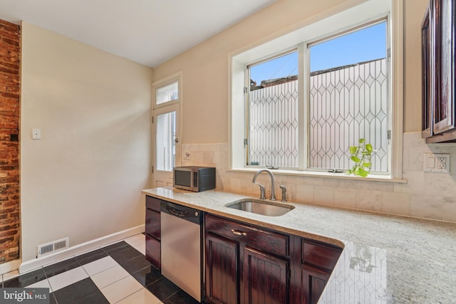 109 N Collington Ave, Baltimore, MD 21231 - kitchen featuring stainless steel appliances, plenty of natural light, decorative backsplash, and light stone counters