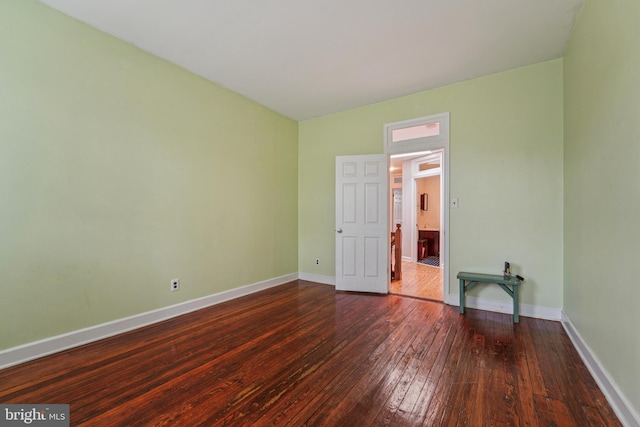 109 N Collington Ave, Baltimore, MD 21231 - unfurnished bedroom with dark wood-style flooring and baseboards