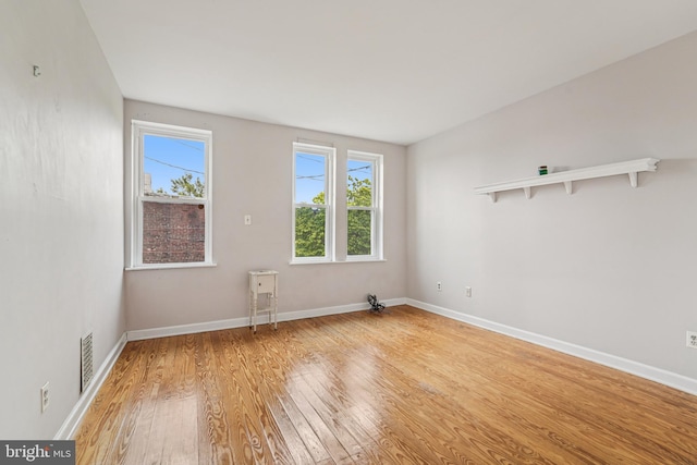 109 N Collington Ave, Baltimore, MD 21231 - empty room with light wood-style flooring and healthy amount of natural light