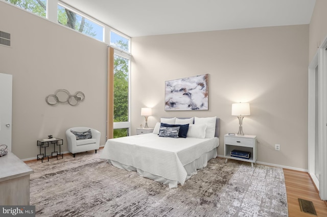 bedroom with wood finished floors and baseboards