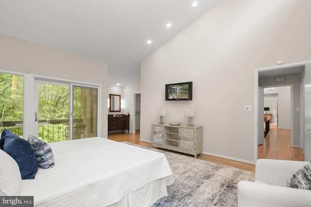 bedroom featuring access to outside, light wood-style floors, recessed lighting, high vaulted ceiling, and baseboards