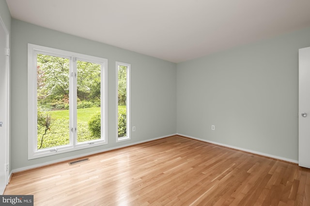 spare room with light wood finished floors and baseboards