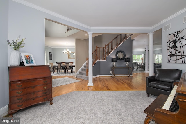 28 Blue Spruce Dr, Bear, DE 19701 - carpeted living area with ornate columns, stairs, crown molding, wood finished floors, and baseboards