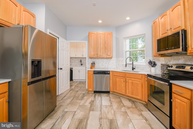 28 Blue Spruce Dr, Bear, DE 19701 - kitchen featuring appliances with stainless steel finishes, a sink, light countertops, backsplash, and recessed lighting