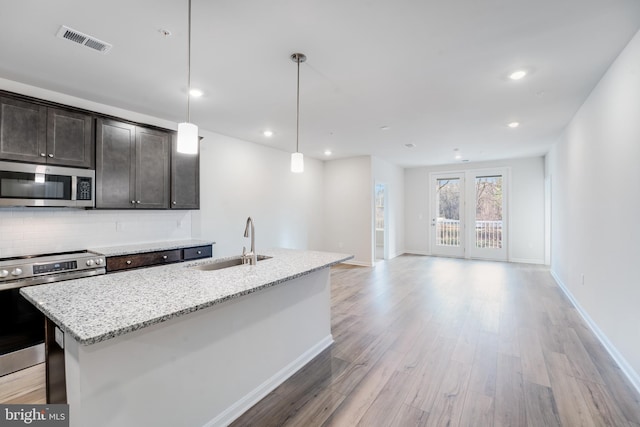 4003 Seaside Alder Rd Unit 0208, Rose, Bowie, MD 20720 - kitchen with appliances with stainless steel finishes, a sink, backsplash, a kitchen island with sink, and light wood-type flooring