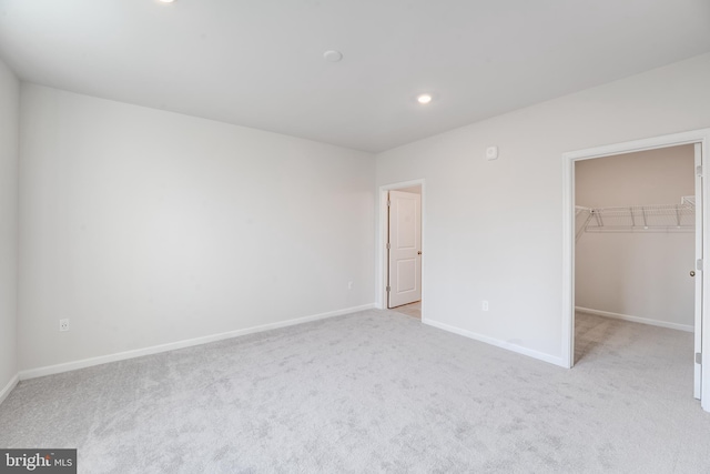4003 Seaside Alder Rd Unit 0208, Rose, Bowie, MD 20720 - unfurnished bedroom featuring light colored carpet, a walk in closet, baseboards, recessed lighting, and a closet