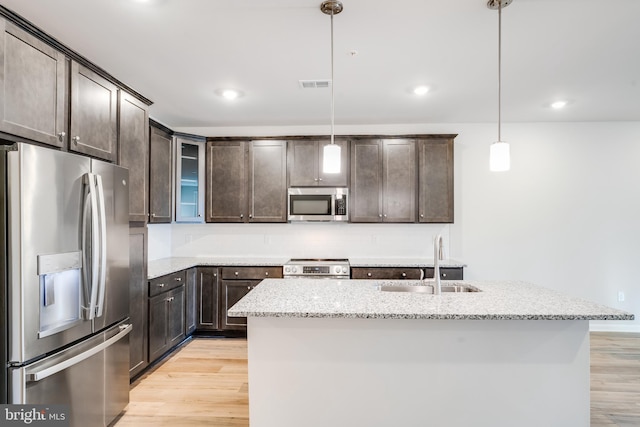 4003 Seaside Alder Rd Unit 0208, Rose, Bowie, MD 20720 - kitchen featuring stainless steel appliances, a sink, dark brown cabinets, light wood-style floors, and light stone counters