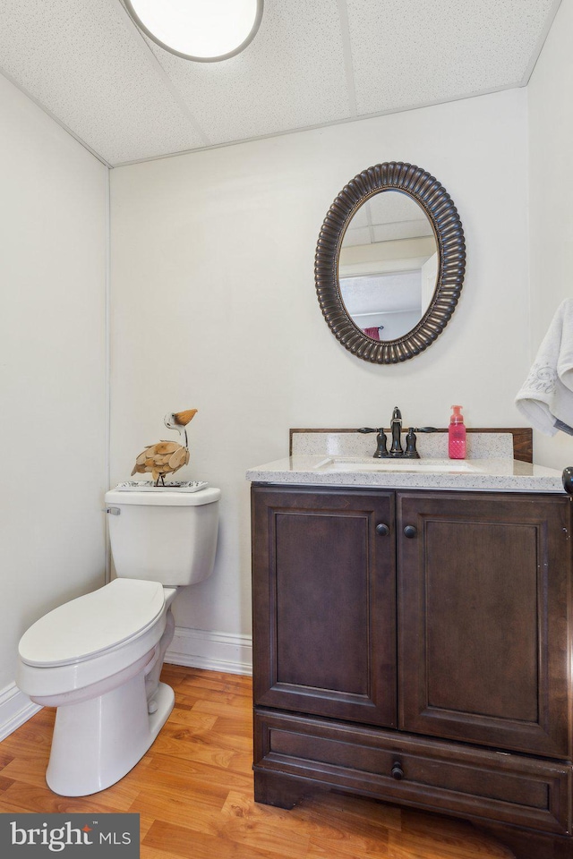 35 N Cleveland Ave, Hagerstown, MD 21740 - half bathroom featuring toilet, vanity, wood finished floors, and baseboards