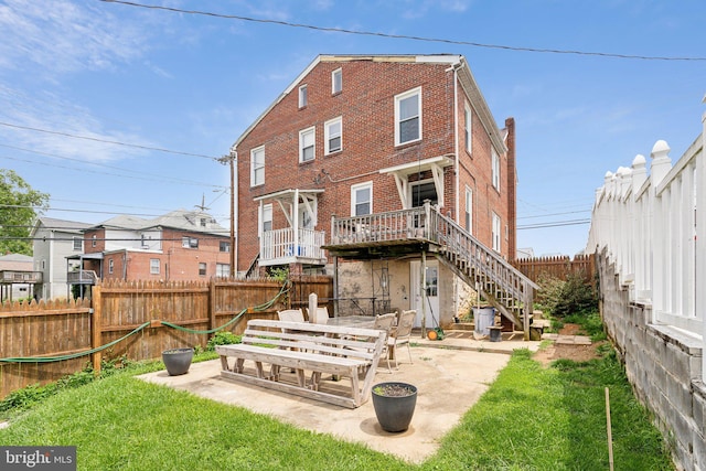 35 N Cleveland Ave, Hagerstown, MD 21740 - rear view of house with stairway, brick siding, and a patio