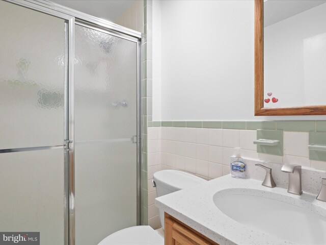 5281 Navaho Dr, Alexandria, VA 22312 - full bath featuring vanity, toilet, a stall shower, tile walls, and a wainscoted wall