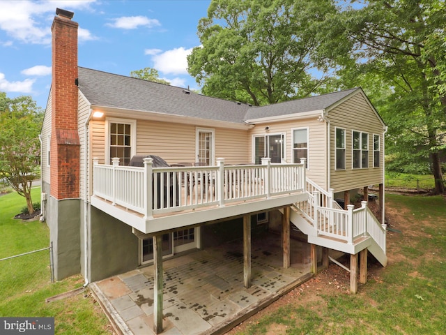 5281 Navaho Dr, Alexandria, VA 22312 - back of house with a chimney, a deck, a lawn, a patio area, and stairway