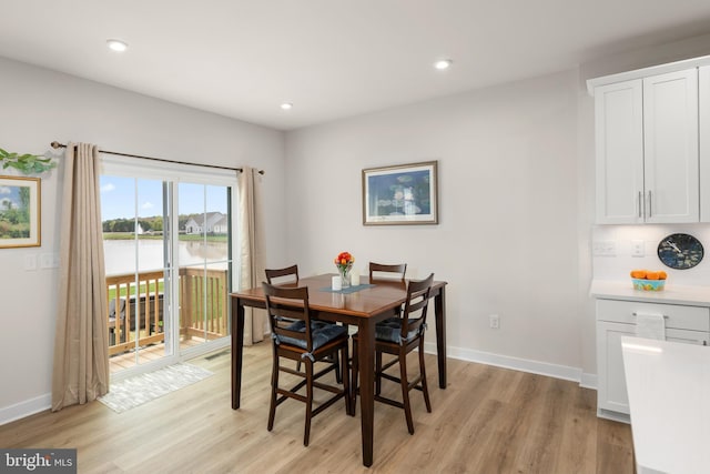 30366 Indigo Way, Georgetown, DE 19947 - dining space featuring light wood-style flooring, baseboards, recessed lighting, and a water view