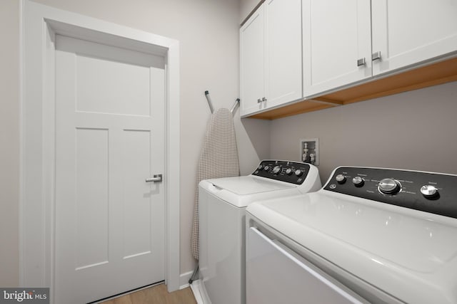 30366 Indigo Way, Georgetown, DE 19947 - laundry room with washer and clothes dryer, cabinet space, and light wood-type flooring
