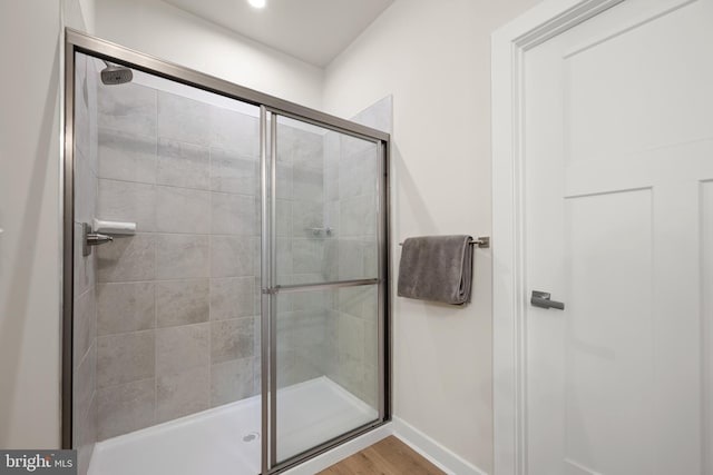 30366 Indigo Way, Georgetown, DE 19947 - bathroom featuring a shower stall, wood finished floors, and baseboards