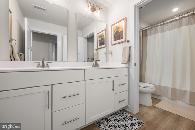 30366 Indigo Way, Georgetown, DE 19947 - full bath with wood finished floors, double vanity, toilet, shower / tub combo with curtain, and recessed lighting