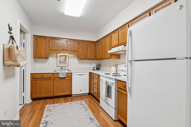 803 Coxswain Way Unit 107, Annapolis, MD 21401 - kitchen with white appliances, under cabinet range hood, a sink, and light countertops