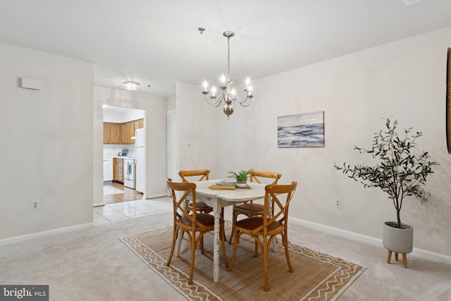 803 Coxswain Way Unit 107, Annapolis, MD 21401 - dining space with light carpet, baseboards, and a chandelier