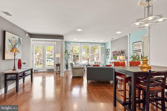 1418 N Rhodes St Unit B105, Arlington, VA 22209 - dining space with wood finished floors, healthy amount of natural light, baseboards, and recessed lighting