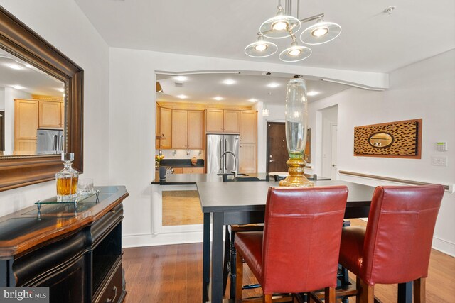 1418 N Rhodes St Unit B105, Arlington, VA 22209 - kitchen featuring stainless steel fridge, dark wood-style flooring, and light brown cabinetry