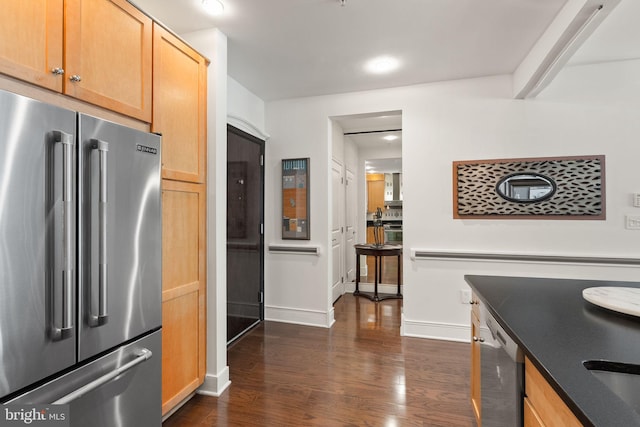 1418 N Rhodes St Unit B105, Arlington, VA 22209 - kitchen with appliances with stainless steel finishes, baseboards, dark wood-style flooring, recessed lighting, and dark countertops