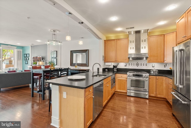 1418 N Rhodes St Unit B105, Arlington, VA 22209 - kitchen with wall chimney exhaust hood, premium appliances, a sink, a peninsula, and dark countertops