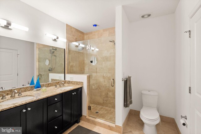 1418 N Rhodes St Unit B105, Arlington, VA 22209 - full bathroom featuring a shower stall, tile patterned flooring, double vanity, toilet, and baseboards