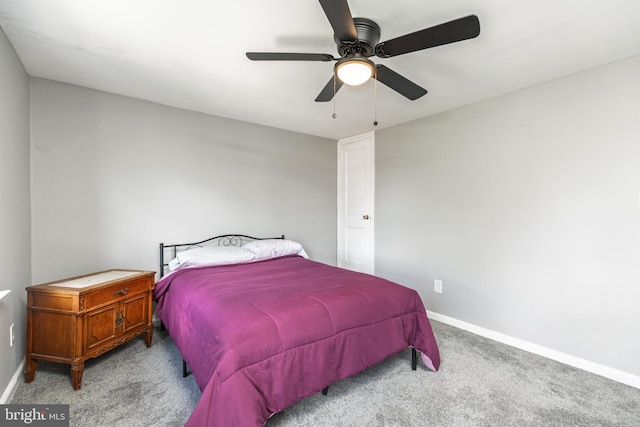 carpeted bedroom featuring baseboards and ceiling fan