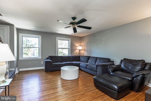 living area with wood finished floors, ceiling fan, and baseboards