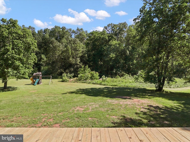 view of grassy yard featuring a playground
