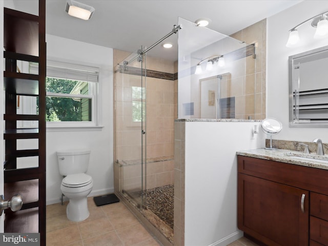 full bathroom featuring a stall shower, toilet, tile patterned flooring, and vanity