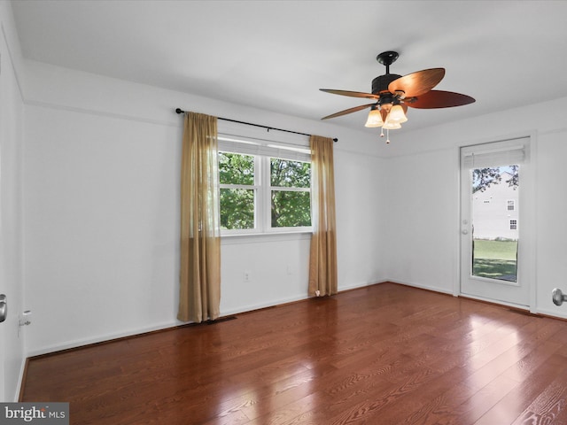 unfurnished room featuring ceiling fan, wood finished floors, and baseboards