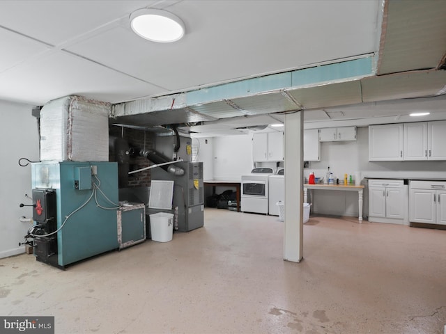 finished below grade area featuring separate washer and dryer and heating unit
