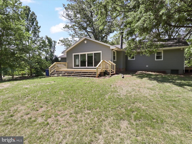 back of house with a wooden deck and a lawn