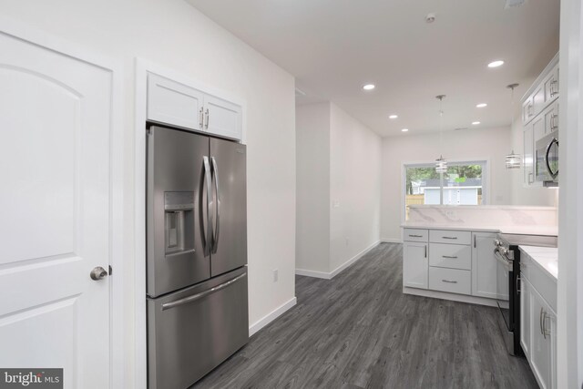 1207 Race St, Cambridge, MD 21613 - kitchen with appliances with stainless steel finishes, dark wood finished floors, a peninsula, white cabinetry, and light countertops