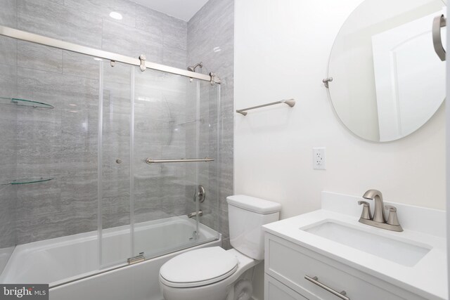 1207 Race St, Cambridge, MD 21613 - bathroom featuring vanity, shower / bath combination with glass door, and toilet