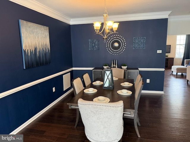 dining space with a chandelier, ornamental molding, wood finished floors, and baseboards
