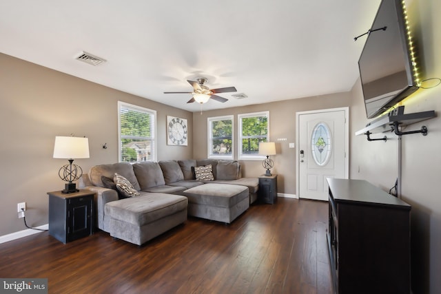 living area with ceiling fan, dark wood-style flooring, and baseboards