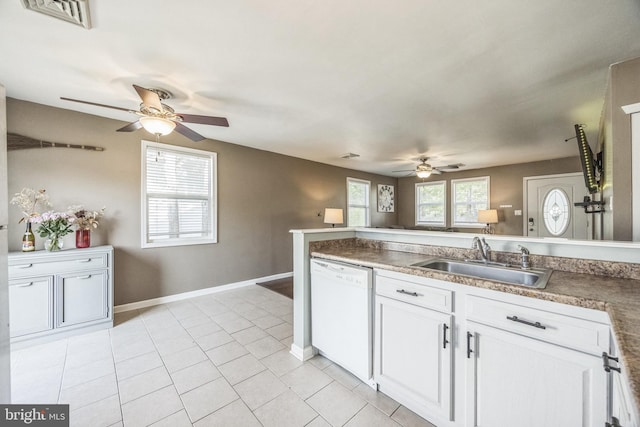 kitchen featuring dishwasher, a sink, a ceiling fan, white cabinetry, and light tile patterned floors