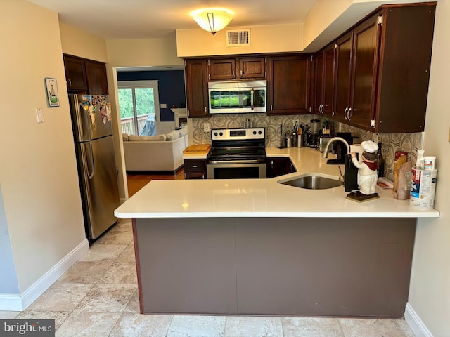 226 Smallwood Ct, West Chester, PA 19380 - kitchen with a sink, appliances with stainless steel finishes, baseboards, and a peninsula