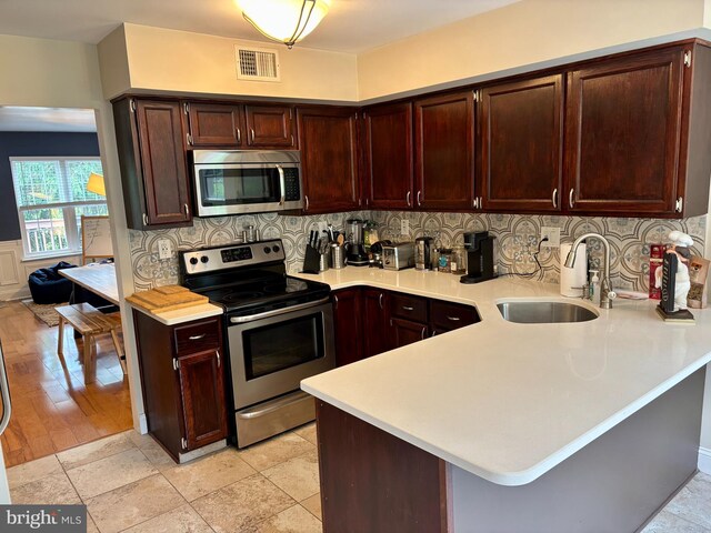 226 Smallwood Ct, West Chester, PA 19380 - kitchen featuring appliances with stainless steel finishes, a sink, light countertops, and a peninsula
