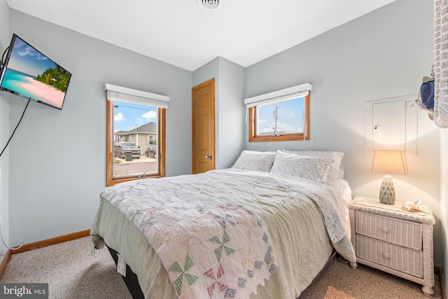 bedroom featuring carpet floors and baseboards
