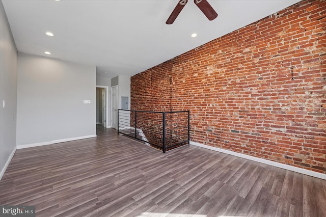 3238 Jasper St, Philadelphia, PA 19134 - empty room with baseboards, wood finished floors, a ceiling fan, brick wall, and recessed lighting