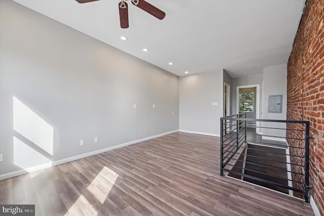 3238 Jasper St, Philadelphia, PA 19134 - spare room with a ceiling fan, wood finished floors, baseboards, brick wall, and recessed lighting