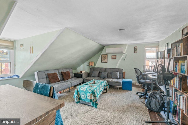 living area featuring a wall mounted AC and vaulted ceiling