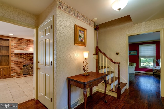 hall featuring wood finished floors, stairway, and baseboards